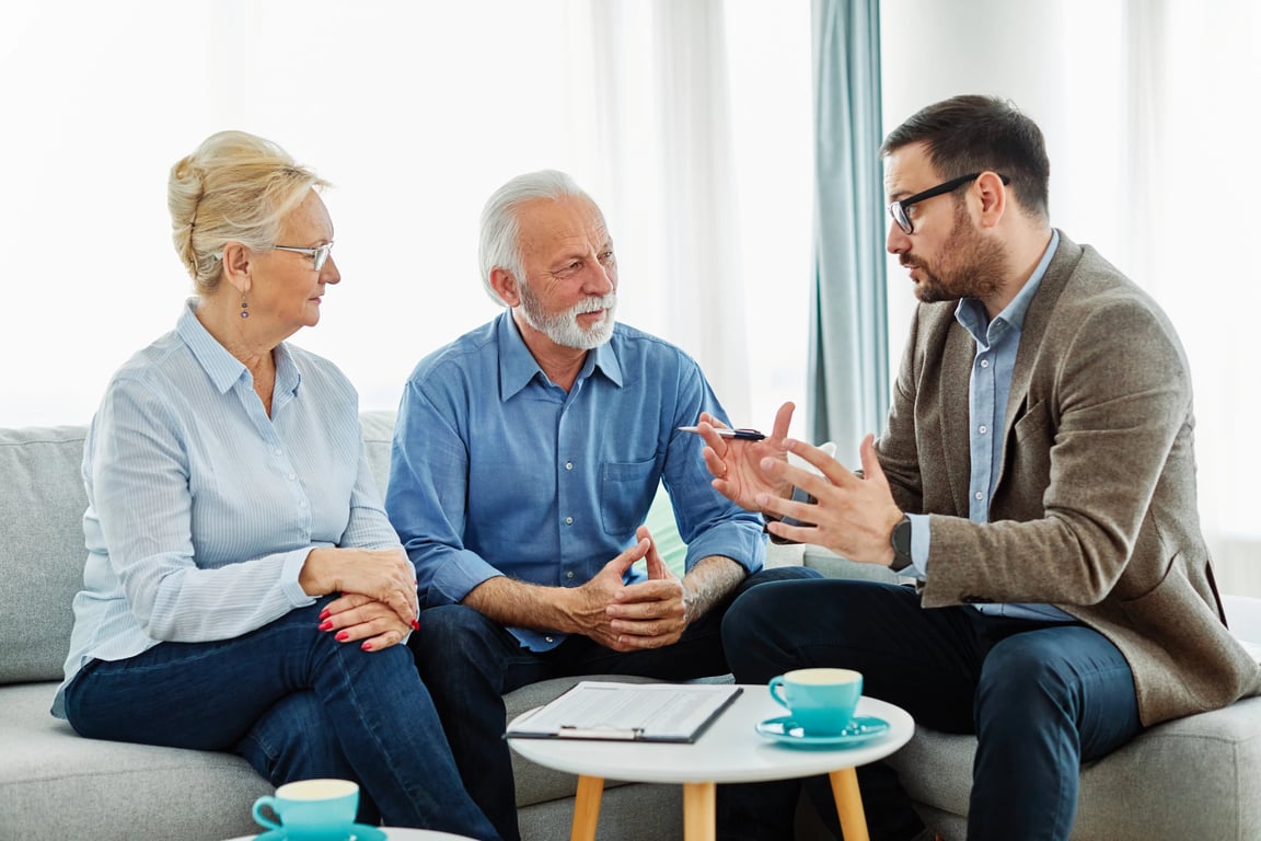 Spectrum Property Solutions representative meeting with former couple to discuss selling their home during divorce.