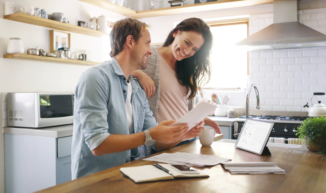 Couple standing in kitchen reviewing a fair cash offer from Spectrum Property Solutions.