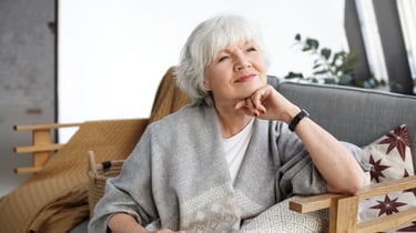 portrait-lovely-middle-aged-grey-haired-european-woman-with-dreamy-smile-eyes-full-wisdom-relaxing-home-alone-sitting-comfortable-couch-reminiscing-about-days-her-youth