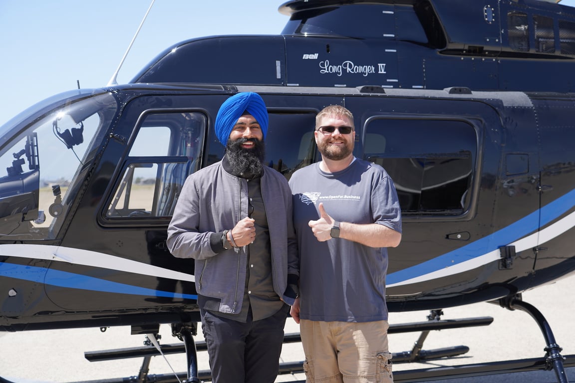 Jaspreet and Steven pose in front of Bell 206L4 Helicopter