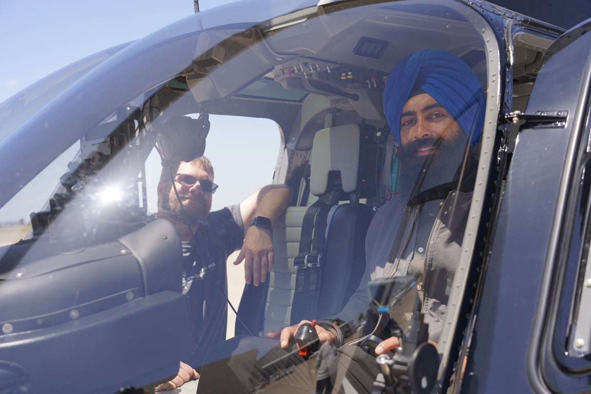 Jaspreet and Steven pose in Bell 206L4 Helicopter