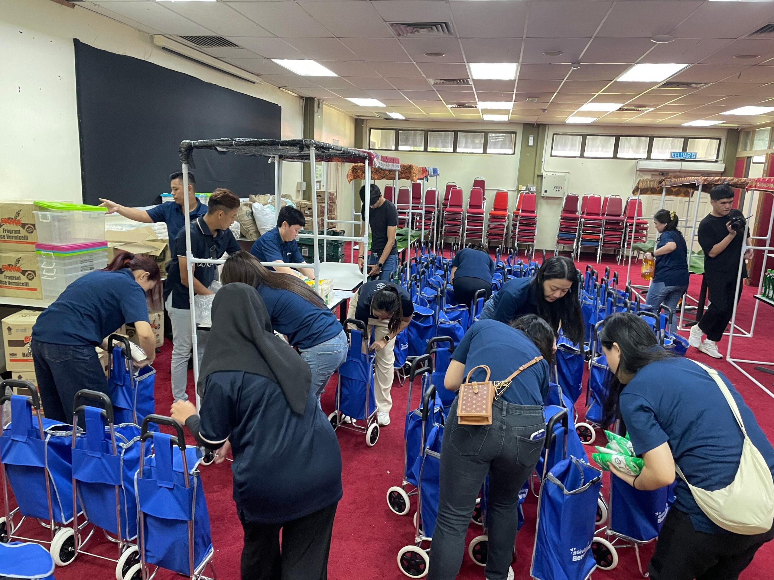 Staff volunteers from CapitaLand assembling and preparing reusable trolley shopping bags 2