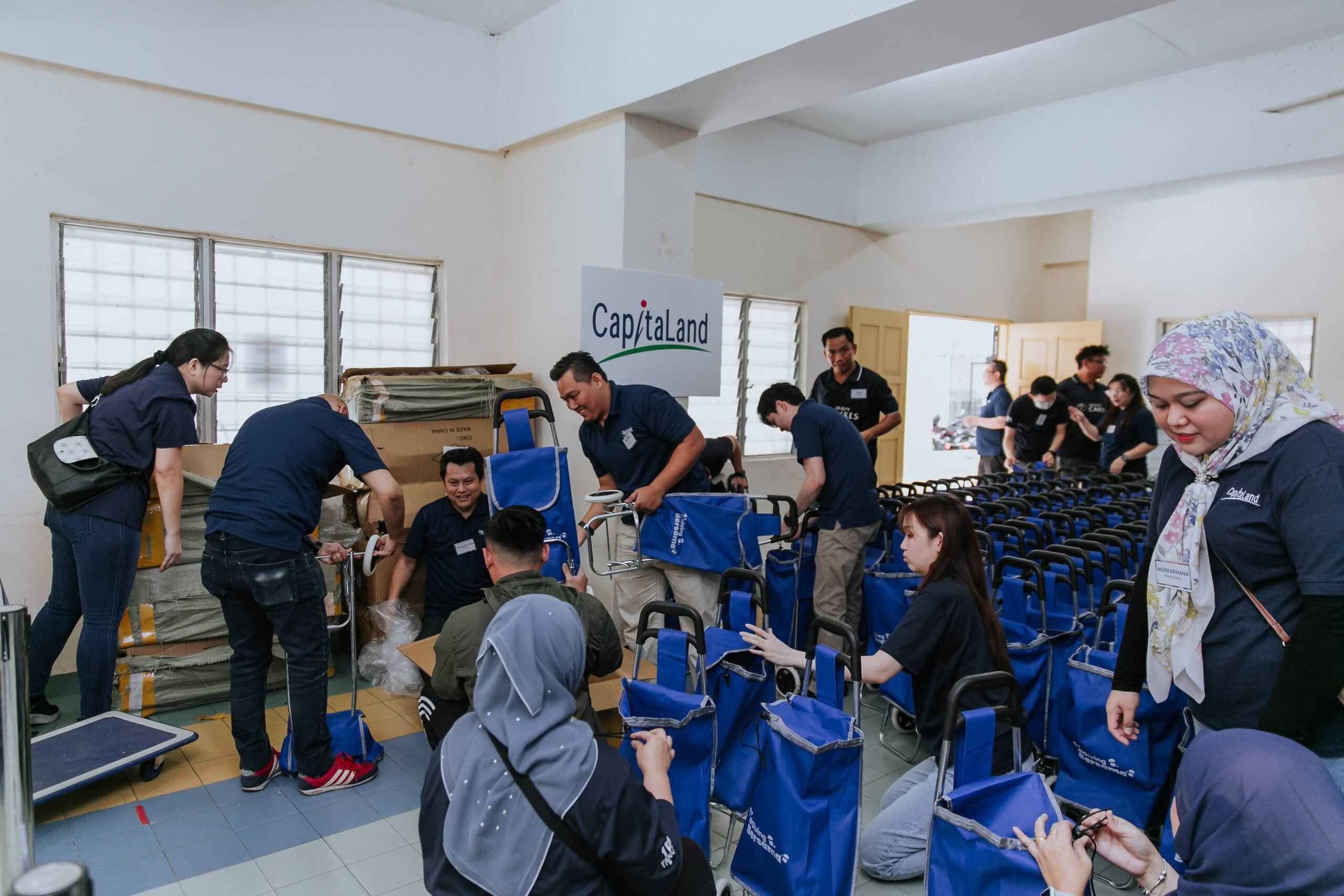 Staff volunteers from CapitaLand assembling and preparing reusable trolley shopping bags 1