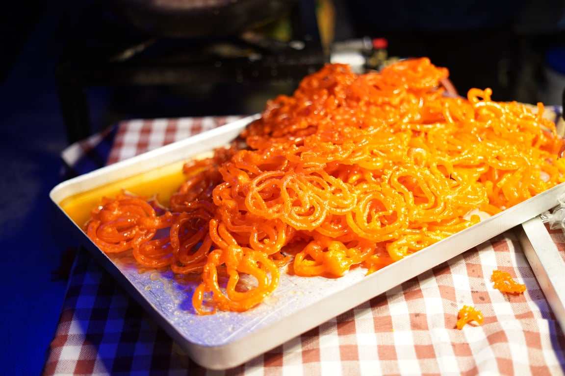 A tray of fresh orange jalebi served at Diwali in Berlin's Indian street-food market