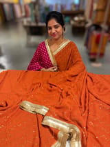 Rust Orange Georgette Saree with stick on Badla in zigzag pattern