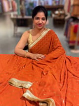 Rust Orange Georgette Saree with stick on Badla in zigzag pattern