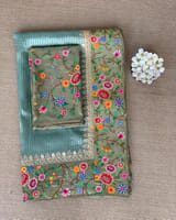 Dusty Blue Tissue Stripes Saree with petite point Embroidered tissue border and blouse .