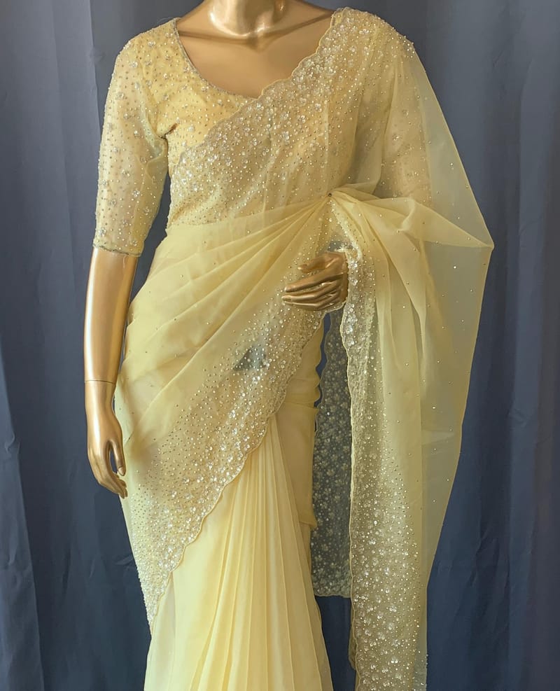 Pastel yellow organza handwork saree