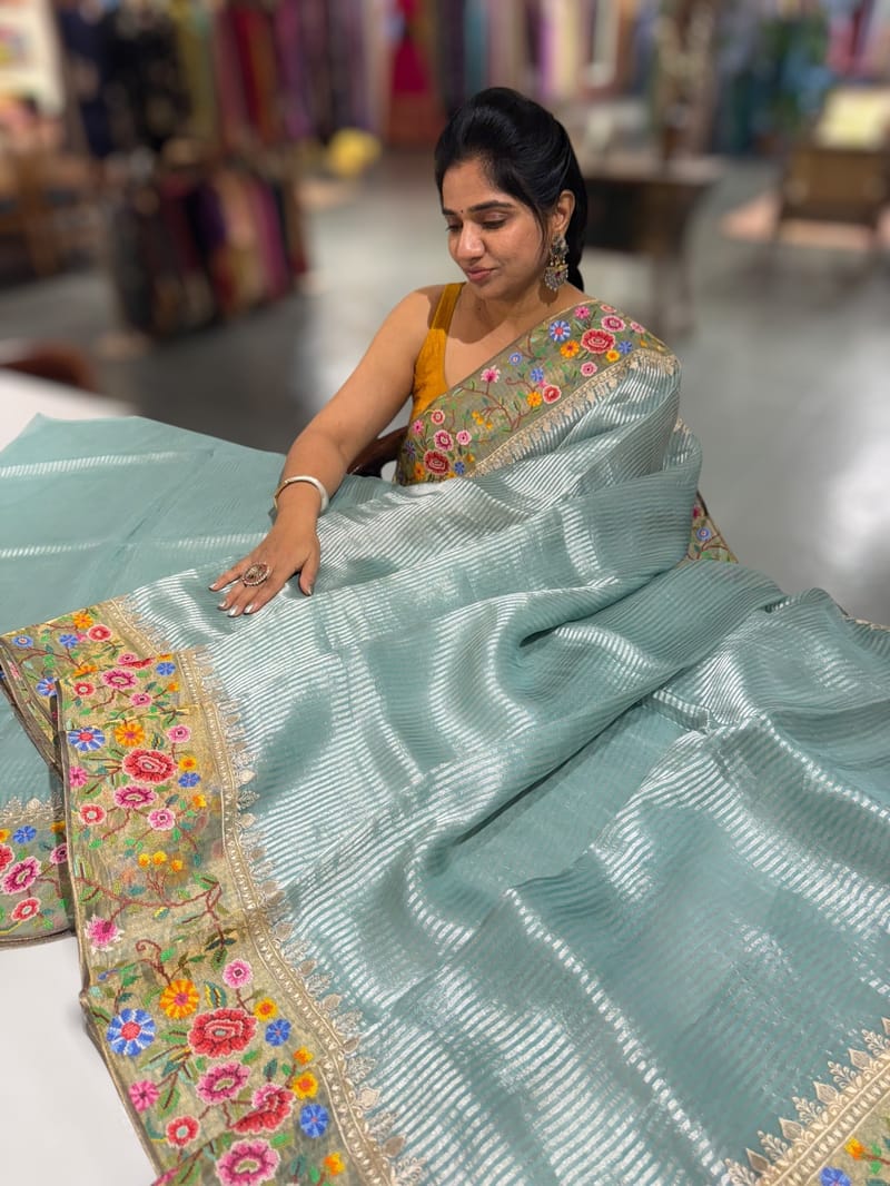 Dusty Blue Tissue Stripes Saree with petite point Embroidered tissue border and blouse .