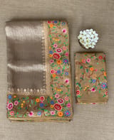 Earthy Tone Tissue Stripes Saree with petite point Embroidered tissue border and blouse .