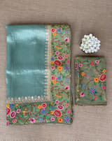 Dusty Blue Tissue Stripes Saree with petite point Embroidered tissue border and blouse .