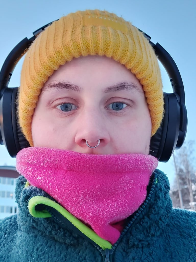 Photo of Erika, a straight edge woman wearing a yellow hat and head phones