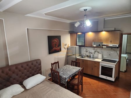 A studio apartment is available for rent near Petro Nini school, opposite the Deshmoret e Lirise high school.