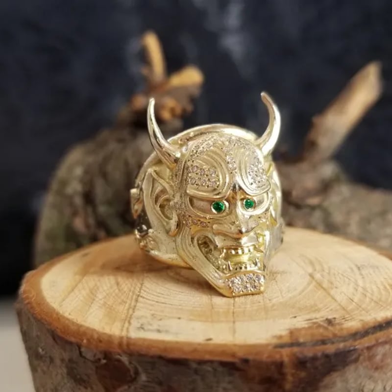 Custom gold ring with diamonds and emeralds