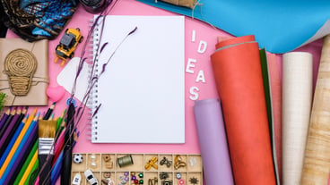 High angle view of various arts and crafts equipment on the table.