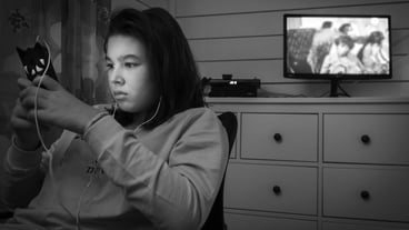 Teenage girl using phone while sitting at home