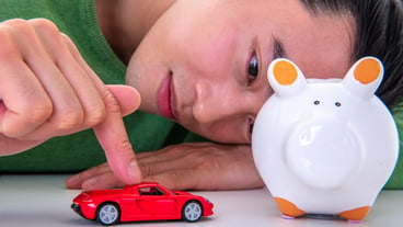 Man with piggy bank and money at home