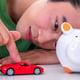 Man with piggy bank and money at home