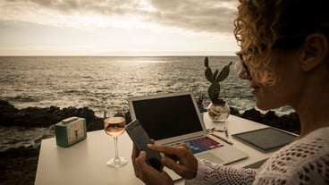 Beautiful professional lady assistant at work in an alternative freedom concept office facing the ocean