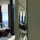 Reflection in mirror of family enjoying meal in restaurant together back view of happy family having
