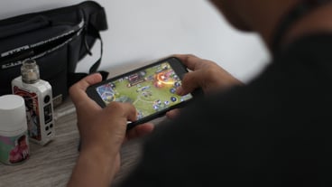 Midsection of man using mobile phone