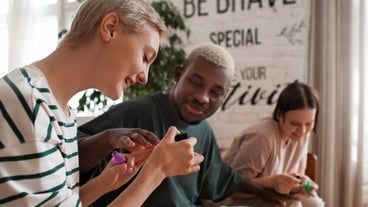 Friends from the side view get a manicure