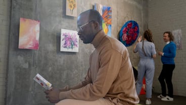 Man reading a brochure in art gallery
