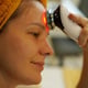 A young woman using an infrared massager