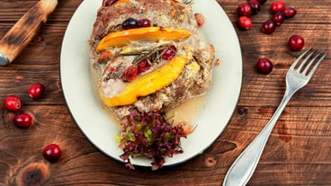 Delicious meatball baked with aromatic mango pieces. Classic meatloaf on a wooden table.