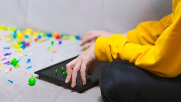 Mid-section of the hand playing the game at the table