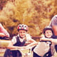 Portrait of happy family on bicycle at park
