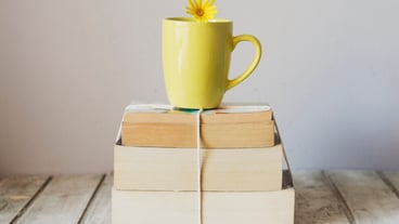 Cup in a pile of books