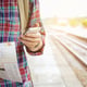 Young tourist with a beard holding a map and using Mobile phone travel concept