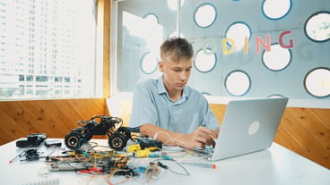 Student working on laptop while analysis car model construction edification