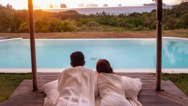 Happy Couple traveler enjoy Beautiful ocean view Tourists relaxing in tropical luxury resort with swimming poolTogether honeymoon love travel and summer vacation concept