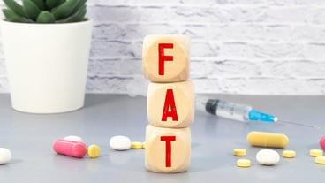 Fat word on wooden blocks Healthy or unhealthy food concept