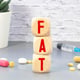 Fat word on wooden blocks Healthy or unhealthy food concept