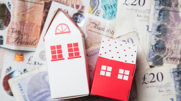 Housing cost Paper toy house with British currency notes