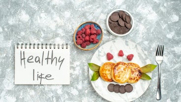 Delicious muffins with honey and chocolate cookies and top view on bright background