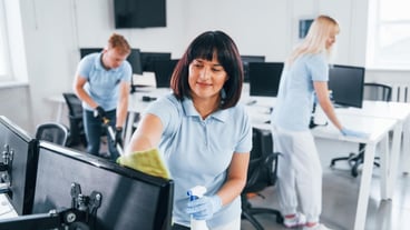 Group of workers clean modern office together at daytime