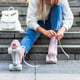 Woman on stairs tying shoelaces on roller skates