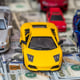 Toy car set on background with US dollar bills