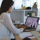 Female fashion designer working on a laptop computer at a desk in a modern office