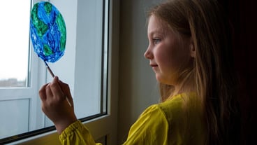 Cute girl painting the planet at home Happy Earth Day ecology saving environment conscious consumption