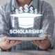 Business girl holding graduation cap. Scholarship