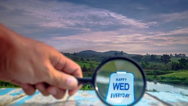 Close-up of hand holding sign against sky