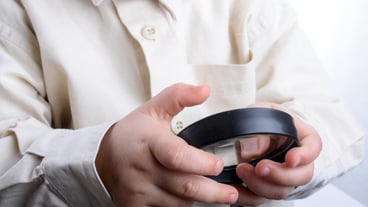 Baby holding a magnifying glass in hand on a white background