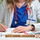 A Doctor is Writing Important Notes Using Scrabble Letters Medical Concept Denoted Carefully
