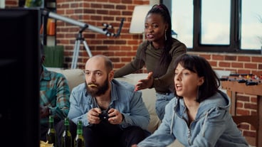 Angry people who lose video games on the TV console are frustrated about the lost game competition. Playing online game and being sad about losing, leisure activities in the group.
