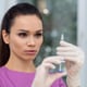 Young doctor using a syringe in a clinic